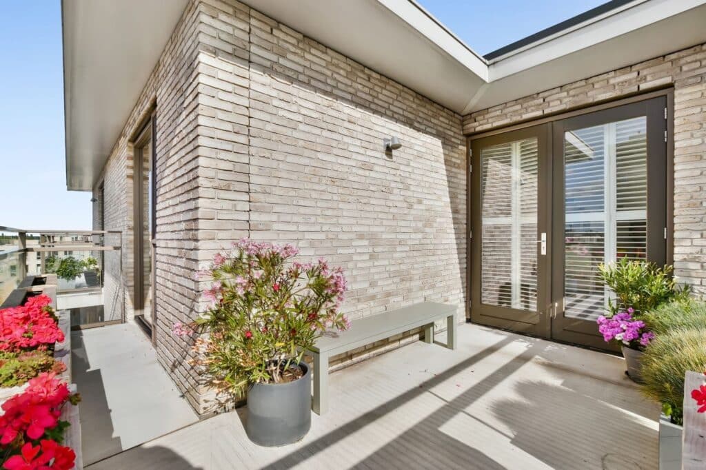 Modern veranda with expert masonry and neatly arranged potted plants