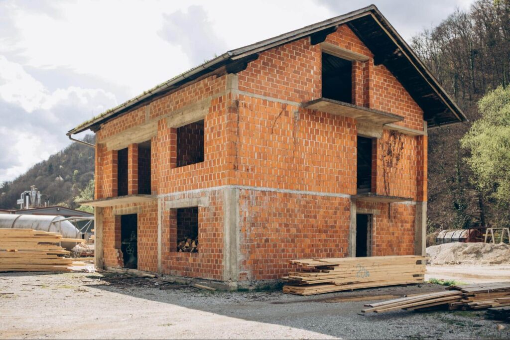 Brick house construction showcasing raw masonry layout.